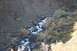 1990 Chevrolet Suburban - A scenic view of a mountain stream cascading over rocks in a gorge during autumn.