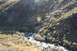 1990 Chevrolet Suburban - A scenic view of a mountain landscape a stream winding through the terrain, surrounded by trees with autumn colors.