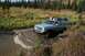 1990 Chevrolet Suburban - This 1990 Chevrolet Suburban navigates a challenging muddy terrain, equipped for off-road adventure.