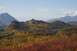 1990 Chevrolet Suburban - A scenic view of mountains covered in colorful autumn leaves, with a small lake visible in the distance.