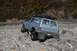1990 Chevrolet Suburban - This 1990 Chevrolet Suburban is navigating a challenging rocky trail with autumn foliage in the background.