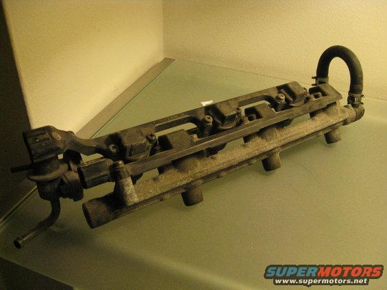 Fuel rail assembly with injectors and a rubber hose attached