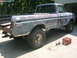 1975 Ford F-250 - This Ford pickup truck is in the process of being prepped for paint, with primer visible on its body panels.