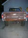 1975 Ford F-250 - The rear of a weathered Ford pickup truck is shown, with the word 'FORD' visible on the tailgate.