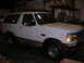 1975 Ford F-250 - This white Ford Bronco is shown from the front three-quarter angle inside a garage or warehouse.