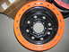 1975 Ford F-250 - A close-up view of an orange and black wheel with a MRW sticker visible on the hub.