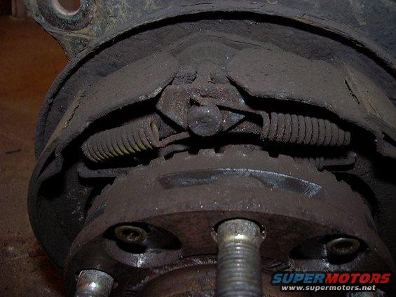 close-up of a dirty drum brake assembly with springs and brake shoes