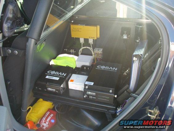 Vehicle interior with Coban devices, yellow GPS unit, and first aid kit