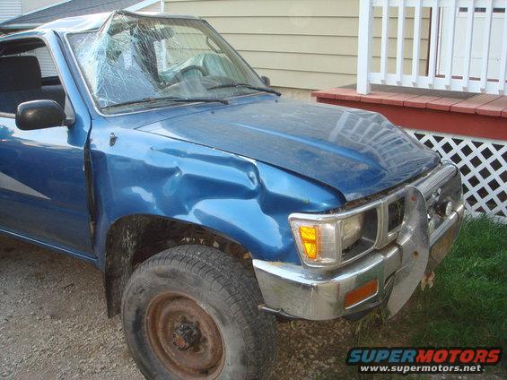 1991 Toyota Tacoma pickup truck with significant front-end damage, including a cracked windshield and dented fender