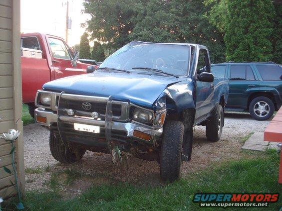 Blue 1991 Toyota Tacoma with damaged front end and bull bar