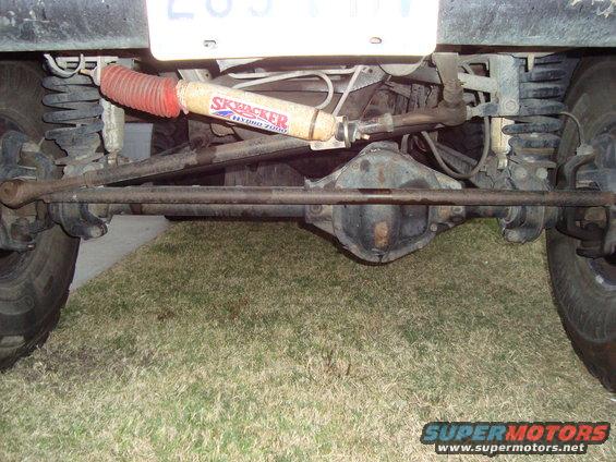 Undercarriage view of a vehicle's rear axle and suspension, showing a Skyjacker Hydro 7000 shock absorber
