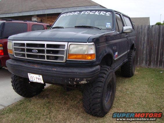 Dark blue 1995 Ford Bronco with lifted suspension and large tires, front 3/4 view