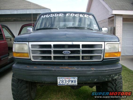 Dark green Ford Bronco front view with "MUDDR FOCKRS" windshield banner and Texas license plate 283-PMV