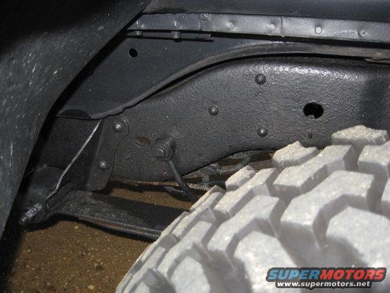 Close-up of a vehicle's frame and a large off-road tire