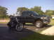 1994 Ford F-250 - Black Ford F-250 pickup truck and motorcycle parked outside on a sunny day.