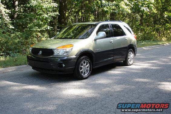 2002 Buick Rendezvous parked on asphalt road with trees in background