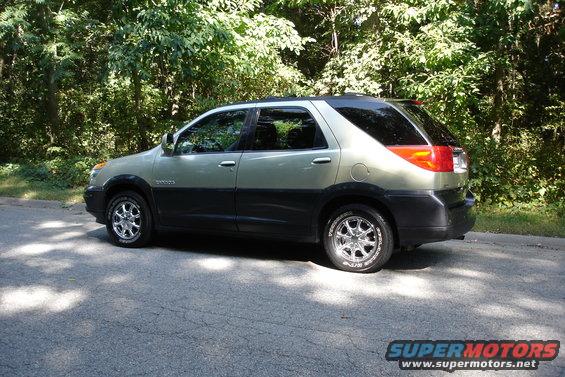 Two-tone SUV parked on a road, side view. 2002 Buick Rendezvous