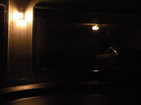 Car parked in a dark garage, side view, dimly lit