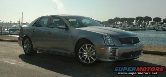 2006 Cadillac STS parked near boats at a marina