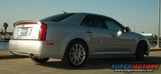 Silver 2006 Cadillac STS parked by the water, showing its rear and side profile