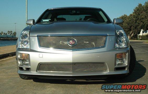 Silver 2006 Cadillac STS front view, grille with Cadillac emblem, clear headlights, parked outdoors