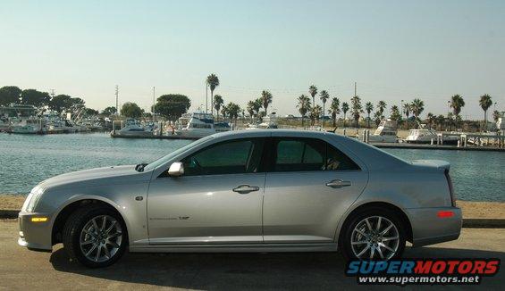 Silver 2006 Cadillac STS sedan parked by a marina, side view