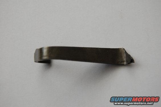 Metal clip on a white background. Supermotors.net logo in the corner