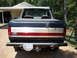 1990 Ford Bronco - This Ford pickup truck features a distinctive red, white, and blue stripe on its tailgate.
