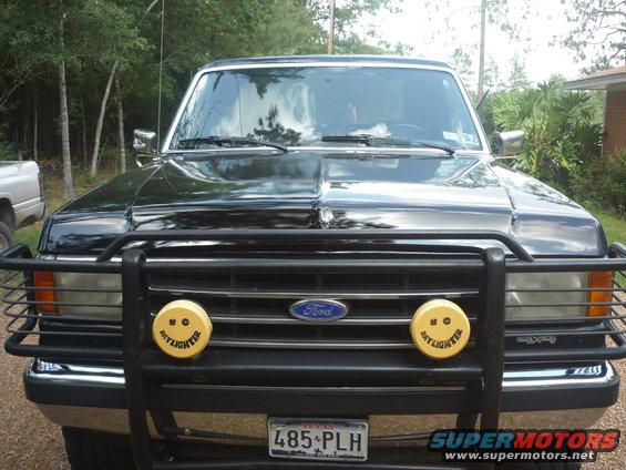 Black 1990 Ford Bronco front view with brush guard and yellow fog lights