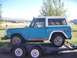 1972 Ford Bronco - A blue and white Ford Bronco is loaded onto a trailer, viewed from the side.