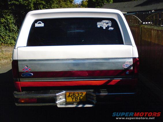 1989 Ford Bronco rear with two stickers on the window and a license plate