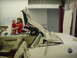 1977 Ford Mustang II - A woman holds a baby inside the interior of a 1977 Ford Mustang II convertible with its top down.