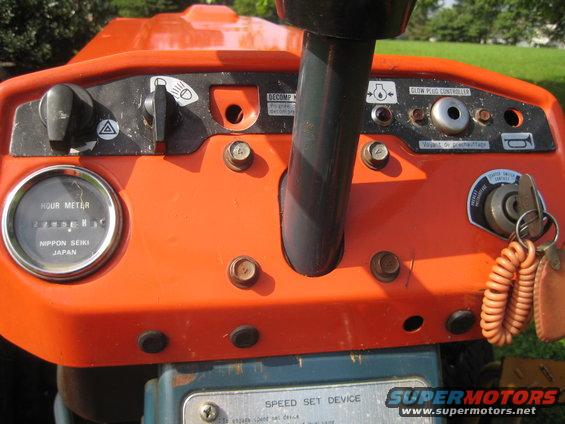 Tractor dashboard with hour meter, ignition, and controls. Nippon Seiki Japan is visible on the hour meter