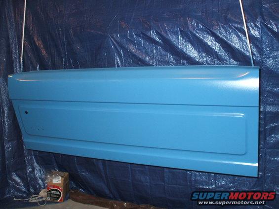 Blue car door, painted, hanging, with a rectangular indentation