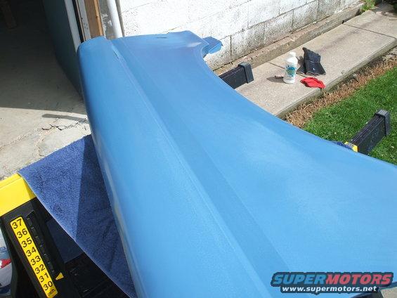 Blue car fender on sawhorses