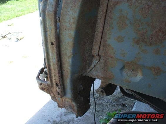 rusted metal fender well with visible bolts and mounting points