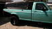 1994 Ford F-150 - This 1994 Ford F-150 pickup has a two-tone paint scheme and a black camper shell.