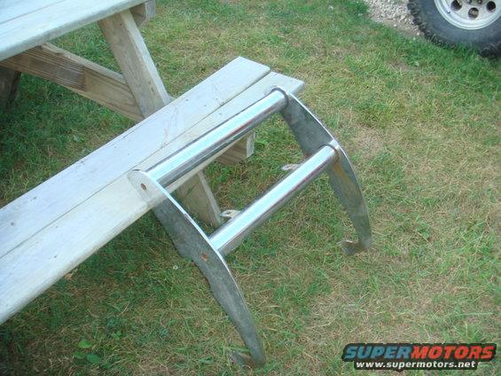 Chrome bull bar resting on a wooden picnic table bench