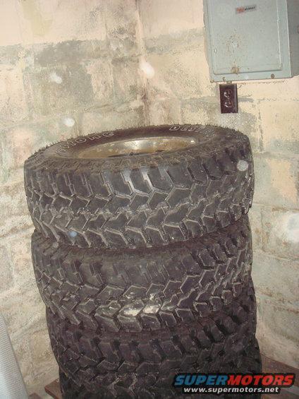 Stack of off-road tires with visible text on sidewall