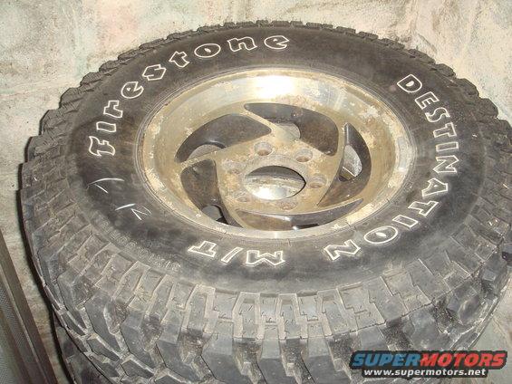 Close-up of a Firestone Destination M/T tire on a dirty alloy wheel