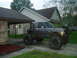 1984 Ford Bronco II - This heavily modified 1984 Ford Bronco II features a custom roll cage and massive off-road tires, giving it a distinct crawler appearance.
