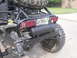 1984 Ford Bronco II - The rear of a heavily modified off-road vehicle is shown, a spare tire and custom external components.