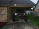 1984 Ford Bronco II - This modified 1984 Ford Bronco II features a custom front bumper and oversized tires, parked under a carport.