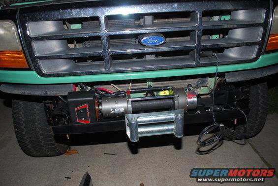 Green 1992 Ford Bronco front end with a chrome grille and a winch mounted on the bumper