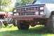 1988 Chevrolet Blazer - The front of a modified SUV is shown next to a tractor, with a custom pipe bumper and large tires.