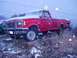 1989 Ford F-250 - A red 1989 Ford F-250 pickup truck is seen in a snowy environment, viewed from the front three-quarter angle.