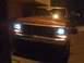 1978 Ford Bronco - Front view of a 1978 Ford Bronco parked at night with headlights illuminated.