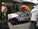 1986 Ford Bronco - A custom-built soap box derby car with Red Bull logos and an umbrella is displayed at an event.