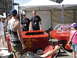 1986 Ford Bronco - A group of people observe a custom-built soap box derby car designed to resemble a fire department vehicle.