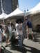 1986 Ford Bronco - Attendees gather under tents at an outdoor event, with some people in costumes and others in everyday attire.